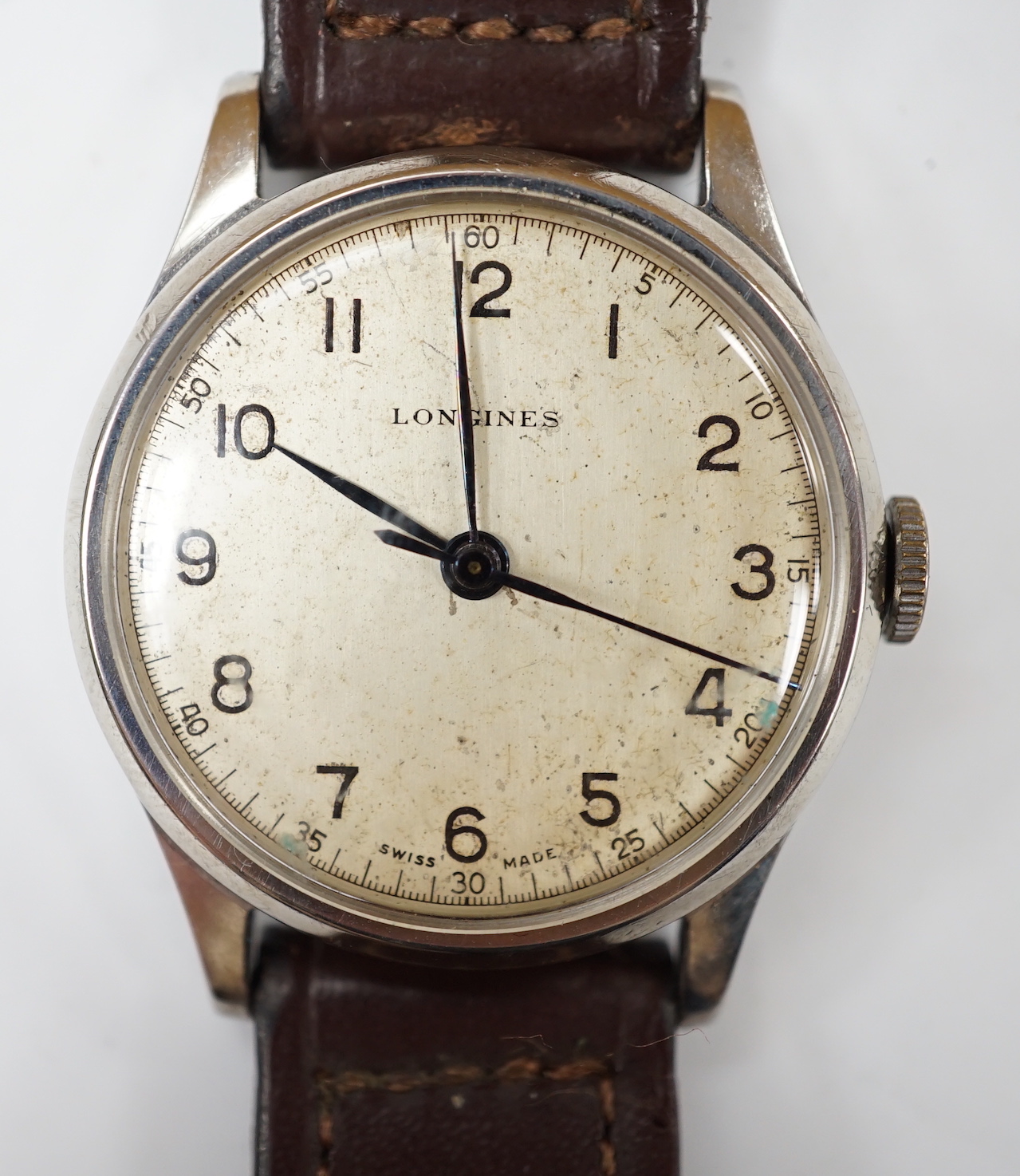 A gentleman's mid 20th century stainless steel Longines manual wind wrist watch, on associated leather strap, case diameter 34mm.